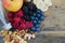 Healthy snack food berry and nuts with fresh spring water bottle on a wooden table