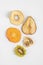 Healthy snack. Homemade dehydrated fruit chips on a white background. Dry kiwi, banana, javblock, persimmon, pear. Dietary