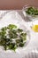 Healthy snack kale chips with salt and seasoning on a baking paper