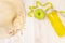 Healthy snack, measuring tape and water bottle on a light wooden background.