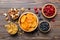 healthy snack: mixed nuts and dried fruits in bowl on table background, almond, pineapple, cranberry, cherry, apricot