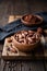 Healthy snack, superfood unroasted cocoa beans in a wooden bowl