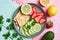 a healthy snack with vegetables, lemon, avocado and crackers