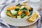 Healthy spinach, avocado and orange salad with ginger-vinegar dressing