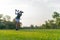 Healthy Sport. Asian Sporty woman golfer player doing golf swing tee off on the green evening time,