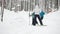 Healthy sport family - mammy and child - skiers in winter snow forest