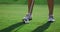Healthy sportswoman play golf on green field course. Golfer hitting ball outside