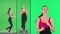 Healthy sporty young woman running and looking at smart watch device on a Green Screen, Chroma Key.