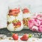 Healthy spring breakfast jars with pink raninkulus flowers, clean eating