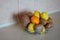 Healthy still life - variety of food. Bowl of different tropic fruits on table