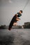 healthy strong guy doing an extreme jump on wakeboard