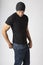 Healthy, strong, slim, slender young man wearing black t-shirt, jeans and knit hat. Young men`s modern casual clothing fashions st