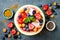 Healthy summer breakfast concept, fruit salad in carved watermelon. Watermelon bowl with yogurt, chia seeds, fresh berries