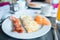 Healthy tasty american breakfast with omlette and bacon on table in cafe