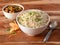 Healthy and tasty veg fried rice and gobi manchurian dry with tomato sauce served in bowl over a rustic wooden background, Indian