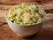 Healthy and tasty veg fried rice made of mixed veggies served in bowl over a rustic wooden background, Indo chinese, Indian