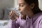 Healthy teenage girl holding glass drinking water at home, closeup