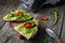 Healthy toast with avocado, goats cheese and arugula