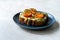 Healthy Toast Tartine with Cream Vegan Cashew Cheese Truffle Flavored, Pesto Sauce and Cherry Tomatoes