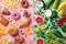 Healthy and unhealthy food background from fruits and vegetables vs fast food, sweets and pastry top view. Diet and detox concept