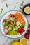 Healthy vegan bowl. Avocado, tomato, Red Radish,carrot, Sunflower seedling,Black pepper, lemon,  and vegetables salad. Top view.