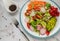 Healthy vegan bowl. Avocado, tomato, Red Radish,carrot, Sunflower seedling,Black pepper, lemon,  and vegetables salad. Top view.