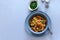 Healthy vegan bowl with quinoa, pumpkin, pepper and carrot on gray wooden background. Selective focus