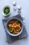 Healthy vegan bowl with quinoa, pumpkin, pepper and carrot on gray wooden background. Selective focus