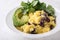 Healthy vegan brunch bowl with  grits, black beans,  avocado