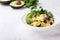 Healthy vegan brunch bowl with  grits, black beans,  avocado