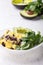 Healthy vegan brunch bowl with  grits, black beans,  avocado