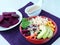 Healthy vegan Buddha bowl, vegetable salad with brown rice, beet, corn, avocado and sesame