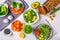 Healthy vegan food lunch, top view. Green salad, sweet potato, vegan cake, vegetables on white background