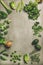 Healthy vegan ingredients layout over concrete table background, vertical composition