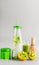 Healthy vegan layered matcha latte drink in bottle with drinking straw standing on table at light gray background. Matcha espresso