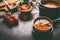 Healthy vegan lentil soup in bowl with spoon on dark kitchen table background with ingredients. Vegetarian food. Clean diet eating