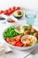 Healthy vegan lunch bowl with falafel hummus tomato avocado peas