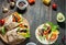 Healthy vegan lunch snack. Tortilla wraps with mushrooms, fresh vegetables and Ingredients on wooden background.