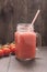 Healthy vegetable. Glass of red tomato juice on wooden table