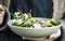 Healthy vegetables salad in bowl, woman with bowl and fork eating healthy salad, clean eating