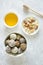 Healthy vegetarian balls with cashews, hazelnuts, peanut butter and almond in the white bowl on the gray background
