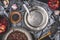 Healthy vegetarian black lentil salad with pomegranate on kitchen table with empty plate and cutlery , top view.