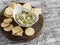 Healthy vegetarian broccoli and pine nuts hummus and homemade cheese biscuits on a wooden rustic board.