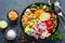 Healthy vegetarian Buddha bowl with fresh vegetable salad, rice, chickpea, avocado, sweet pepper, cucumber, carrot, pomegranate an