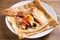 Healthy vegetarian homemade food: crepes or thin pancakes with cheese, egg, tomatoes and mushrooms