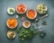 Healthy vegetarian ingredients bowls: diced vegetables, herbs and spices on dark background