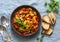 Healthy vegetarian lunch - stewed garden vegetables. Vegetable ratatouille and grilled bread. On a blue background