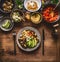 Healthy vegetarian meal. Bowl with chick peas puree, roasted vegetables , red paprika tomatoes stew, avocado and seeds . Clean eat