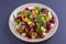 Healthy vegetarian salad with beetroot, green arugula, orange, feta cheese and walnuts on plate