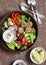 Healthy vegetarian snack set - quinoa meatballs and fresh raw vegetables on wooden table